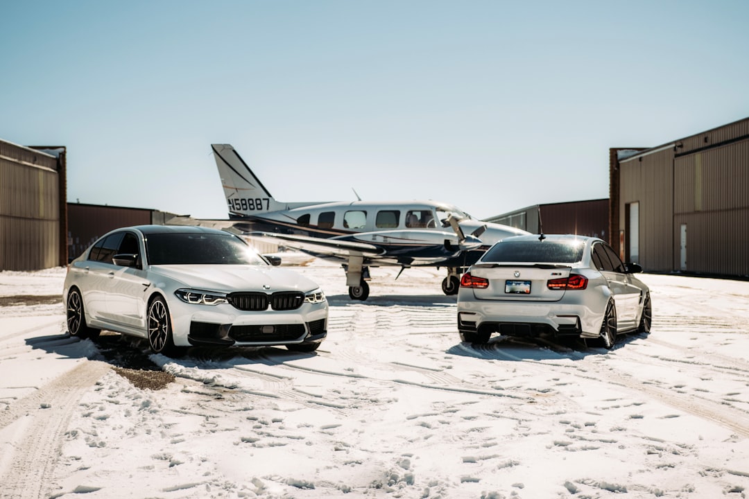 white and black mercedes benz c class on snow covered ground during daytime