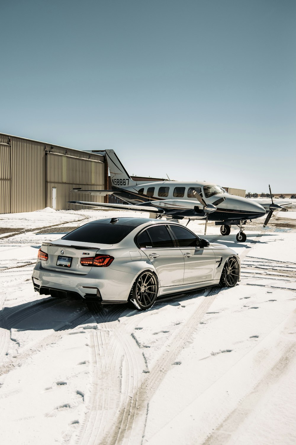 silver sedan parked on snow covered ground during daytime