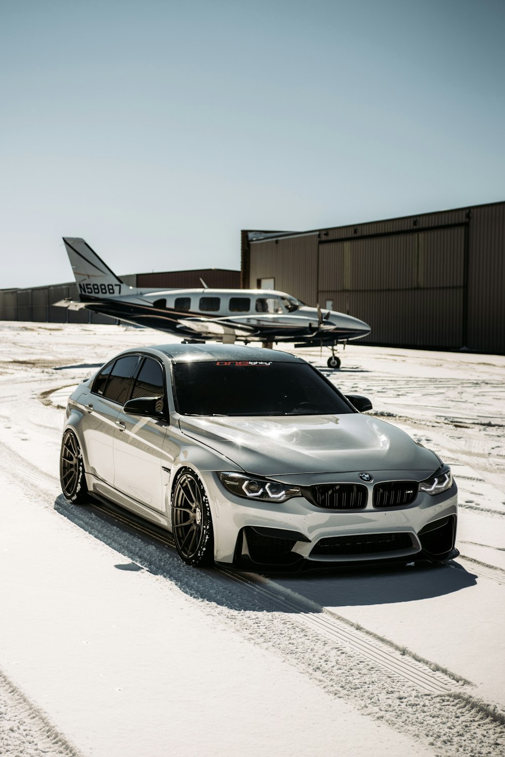 silver mercedes benz coupe on white sand during daytime