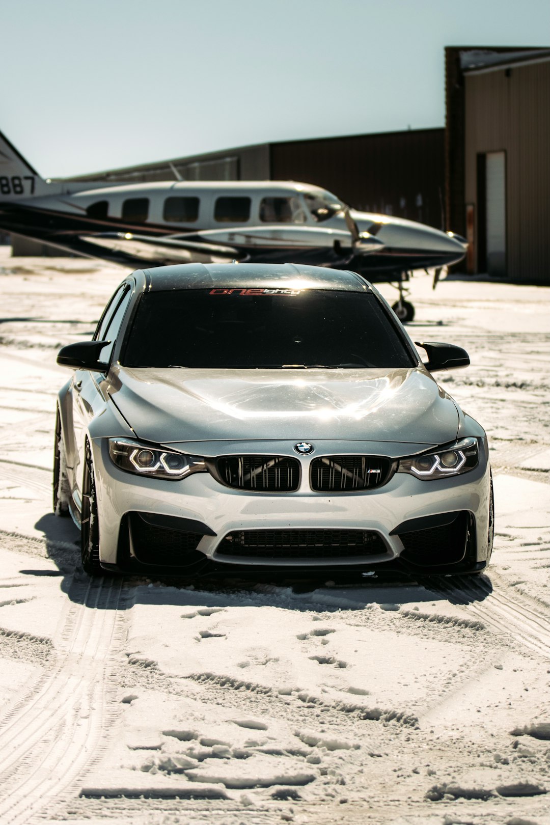 silver bmw m 3 parked on parking lot during daytime