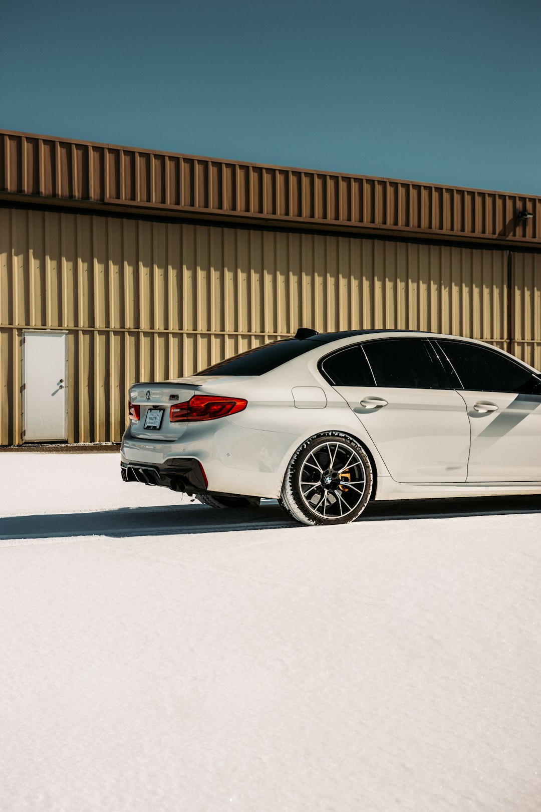 white sedan parked on white snow covered ground