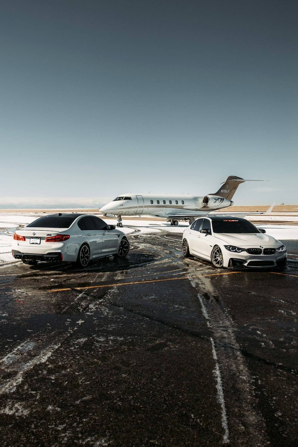 white and black cars on parking lot during daytime