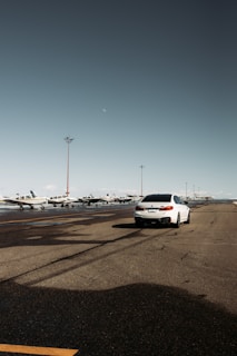 Wide shot of a clean vehicle waiting outside Colombo airport terminal.