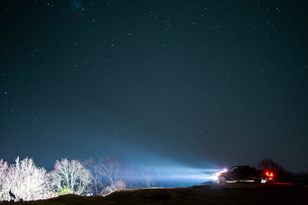 black car on road during night time