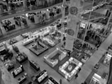 An interior view of a multi-level department store featuring various counters and display units. Mannequins and shelves with items such as clothes, accessories, and other merchandise are visible. The space is well-lit with numerous shoppers moving around.