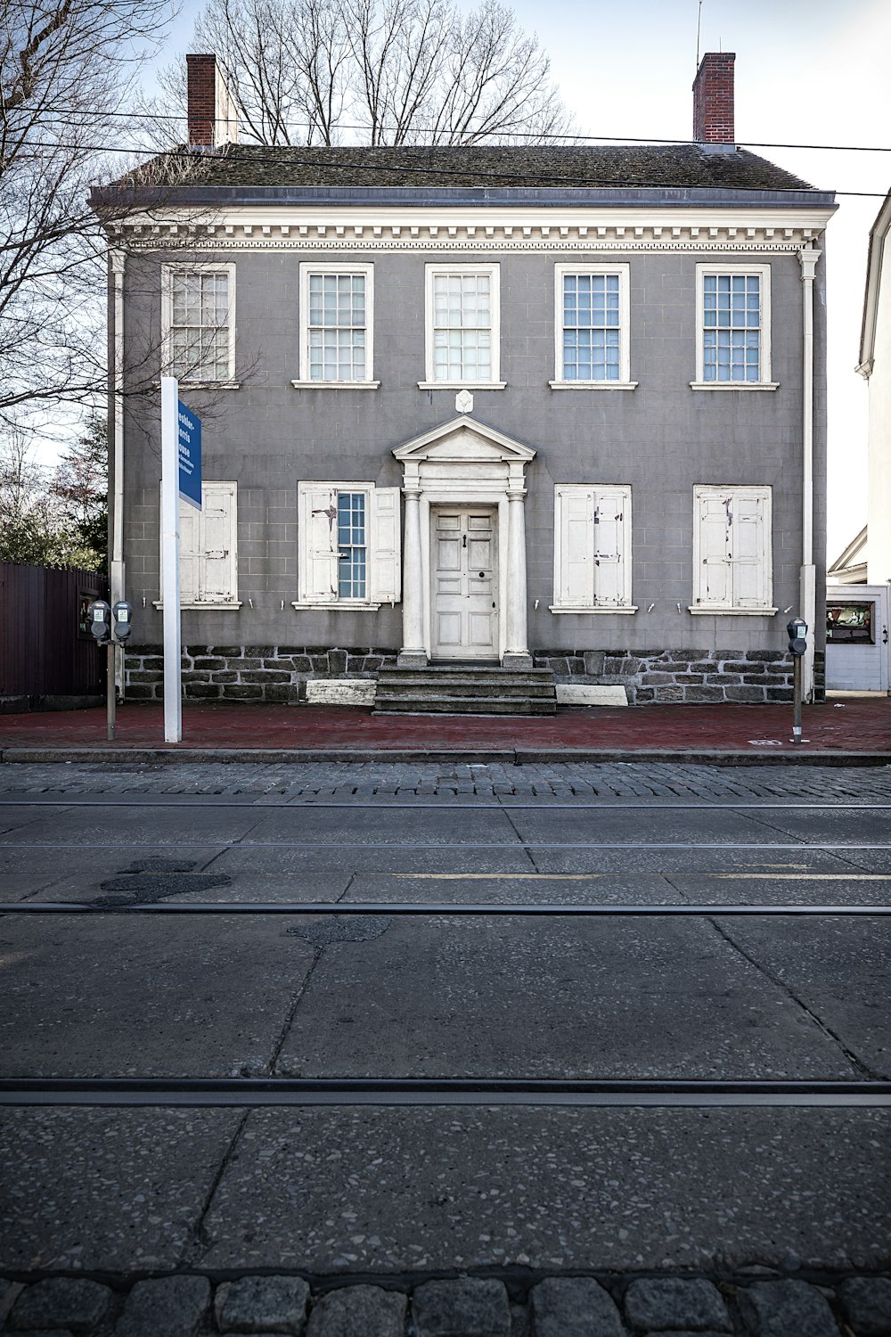 white and brown concrete building near bare trees during daytime