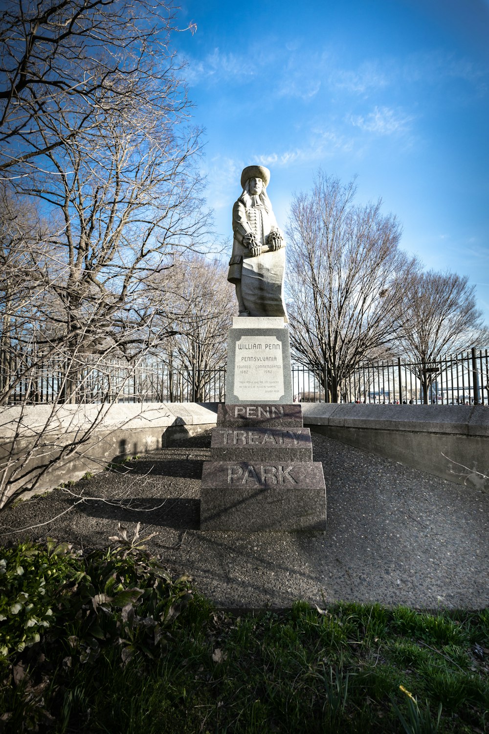 gray concrete statue on gray concrete bench during daytime