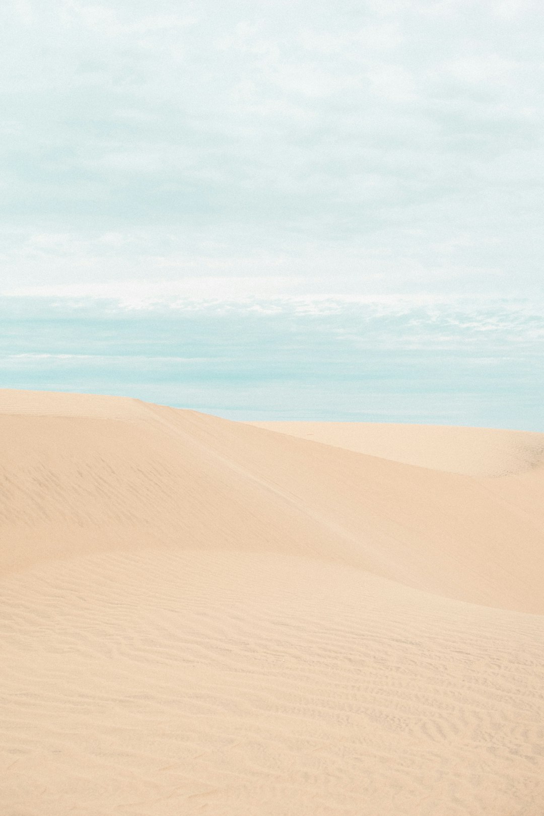 brown sand under blue sky during daytime