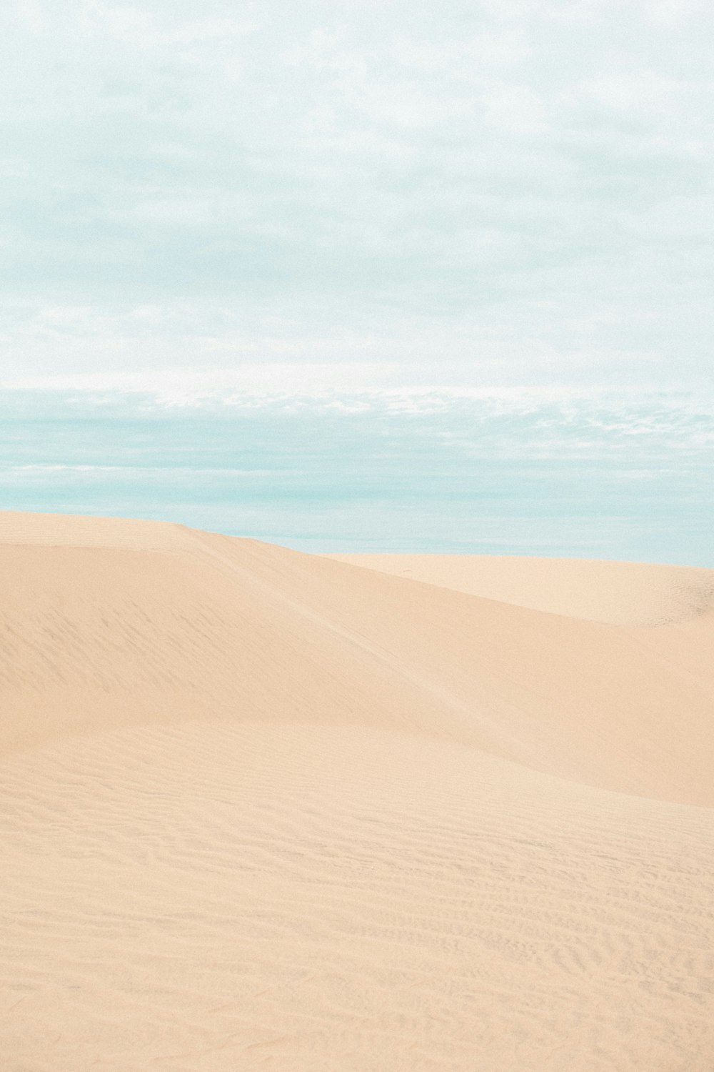 brown sand under blue sky during daytime