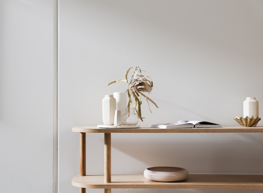 white ceramic figurine on white wooden table