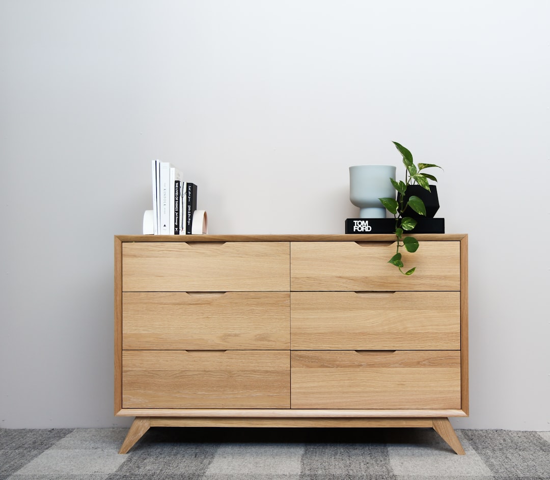 brown wooden cabinet with green plant on top