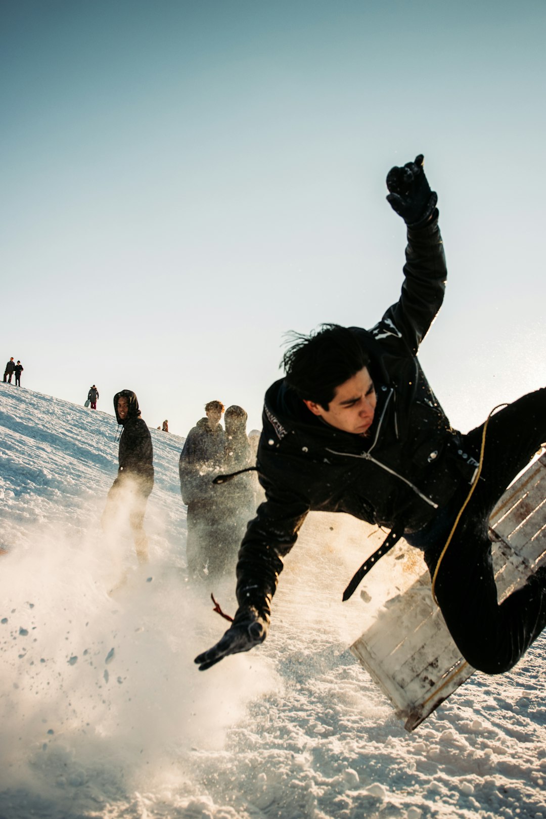 man in black jacket and black pants riding black snowboard