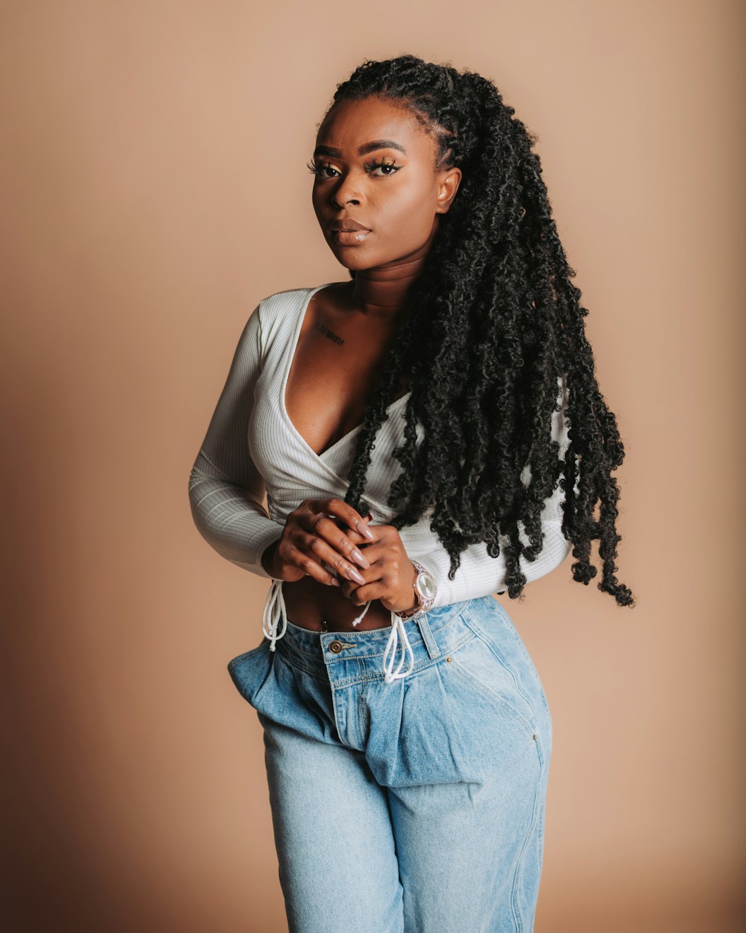 woman in white tank top and blue denim jeans