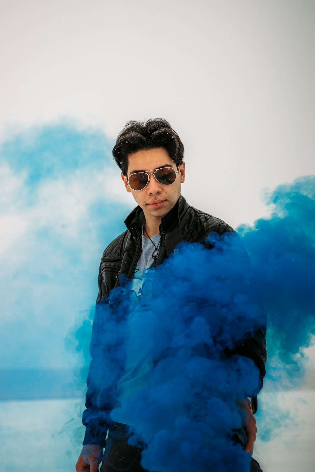 man in black leather jacket wearing black sunglasses