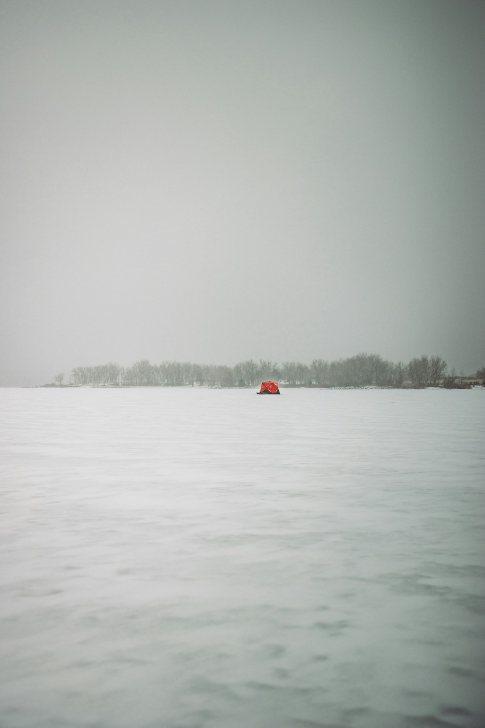 red and white balloon on snow covered ground