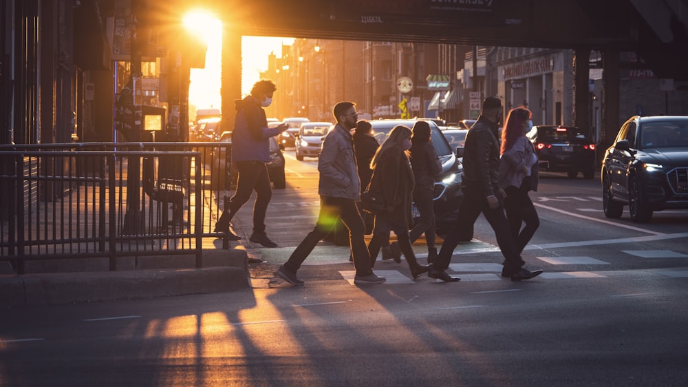 people walking on sidewalk during night time