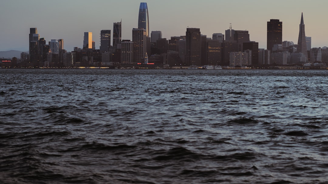 city skyline across body of water during daytime