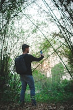 A traveler wearing AR glasses exploring a lush green forest with digital overlays highlighting flora and fauna.