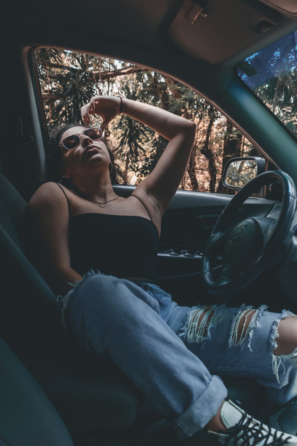 man in blue denim jeans sitting on driver seat