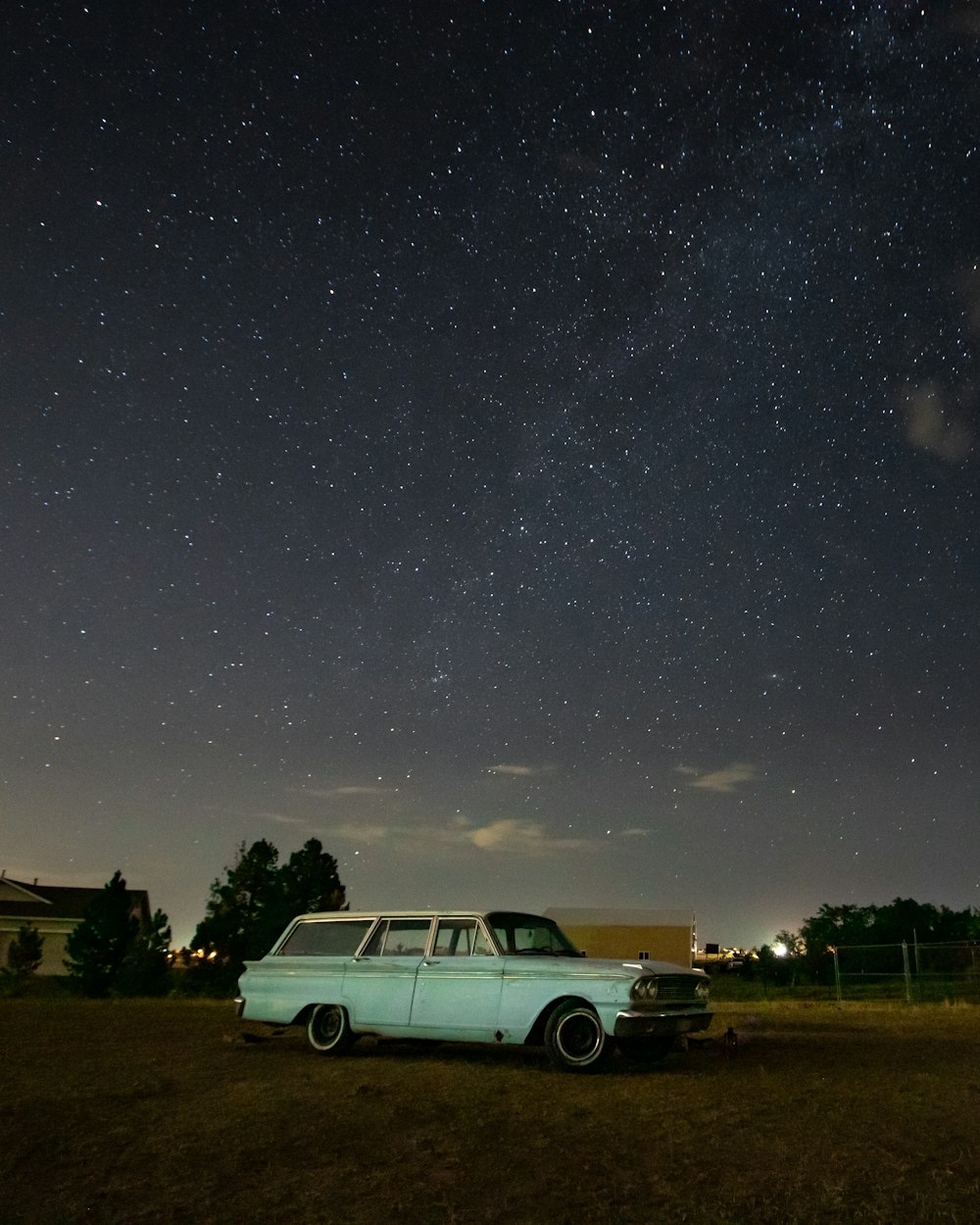 white suv on green grass field under starry night