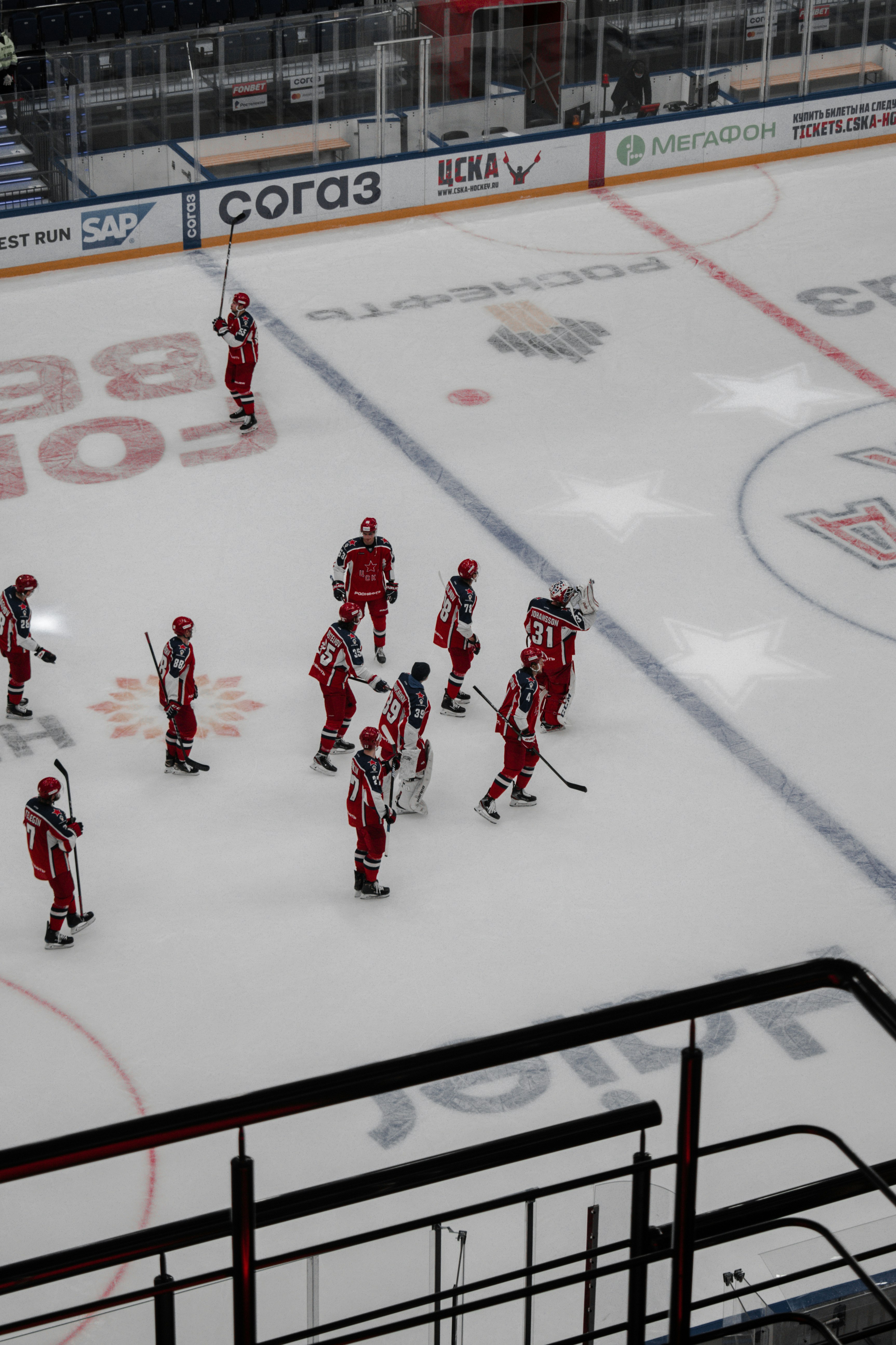 people playing ice hockey on ice field