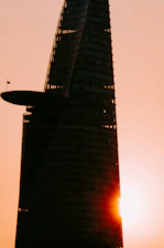 A sleek, modern skyscraper in Baghdad reflecting the dawn light, symbolizing growth and opportunity.