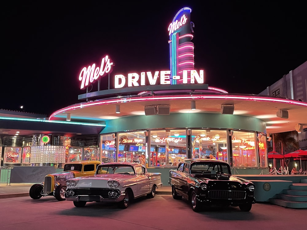 black sedan parked in front of UNKs restaurant during night time