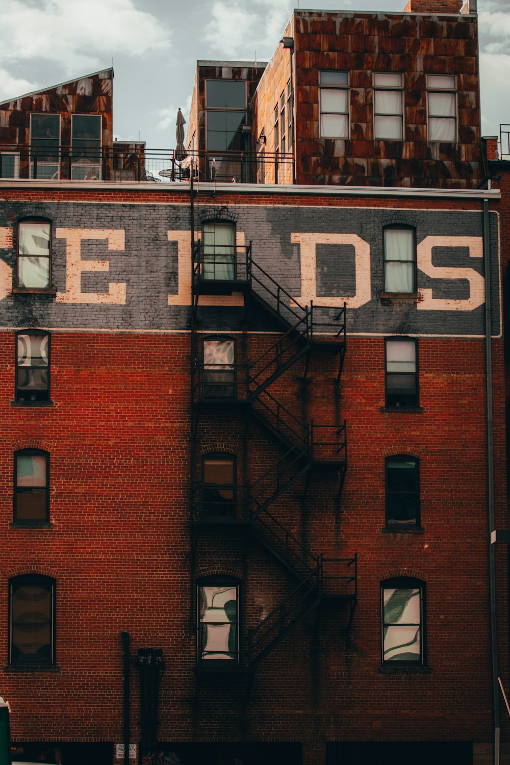 brown brick building with white and black signage