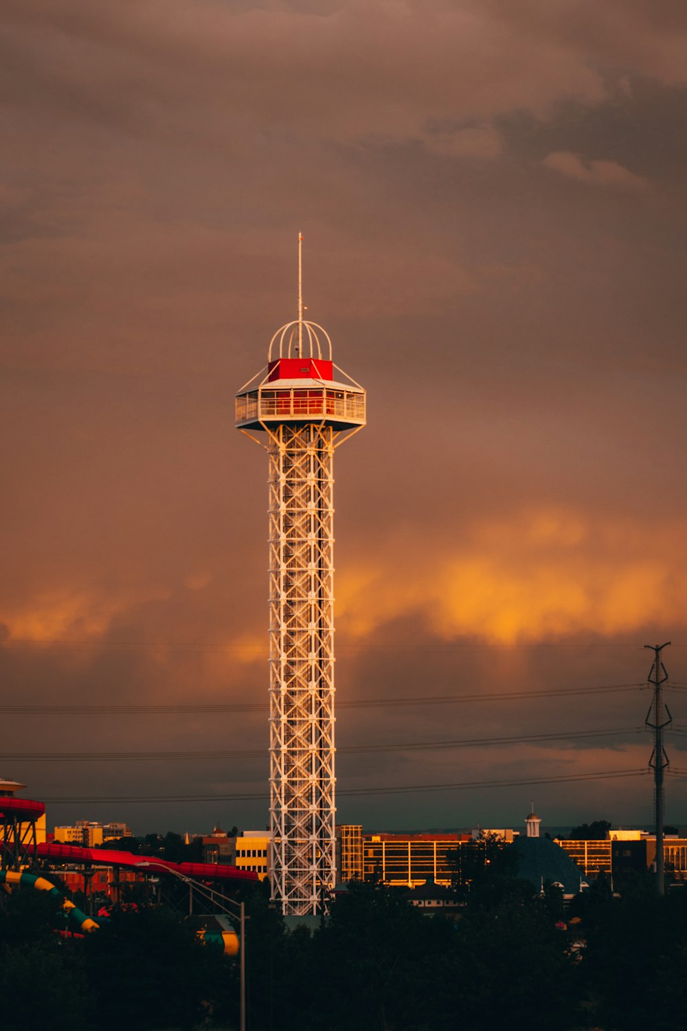white and red tower under cloudy sky during daytime