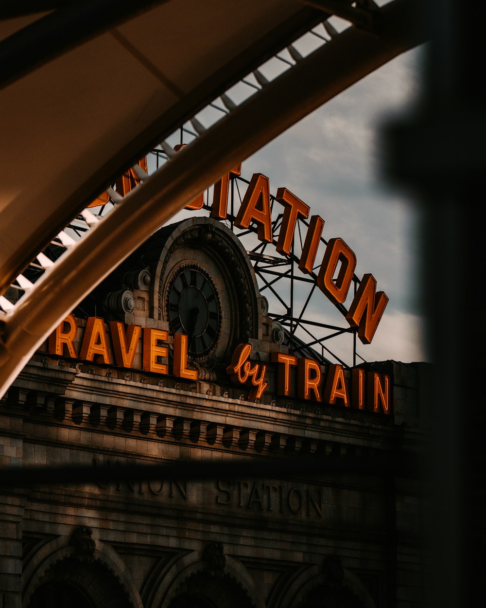 a train station with a sign that says station travel by train