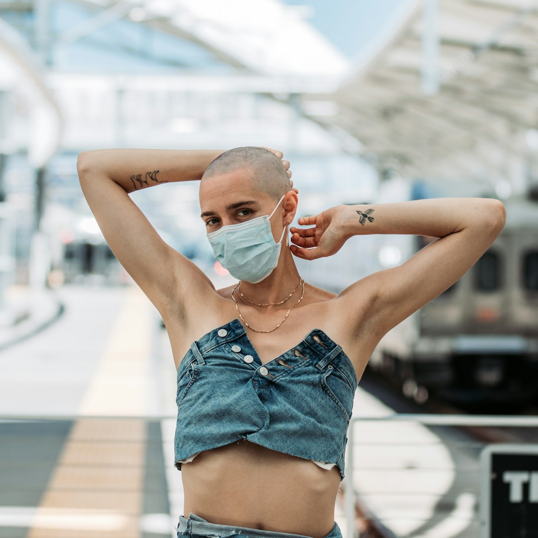 woman in blue denim shorts with white face mask