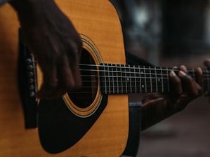 Close-up of acoustic guitar strings being played during an intimate wedding performance.