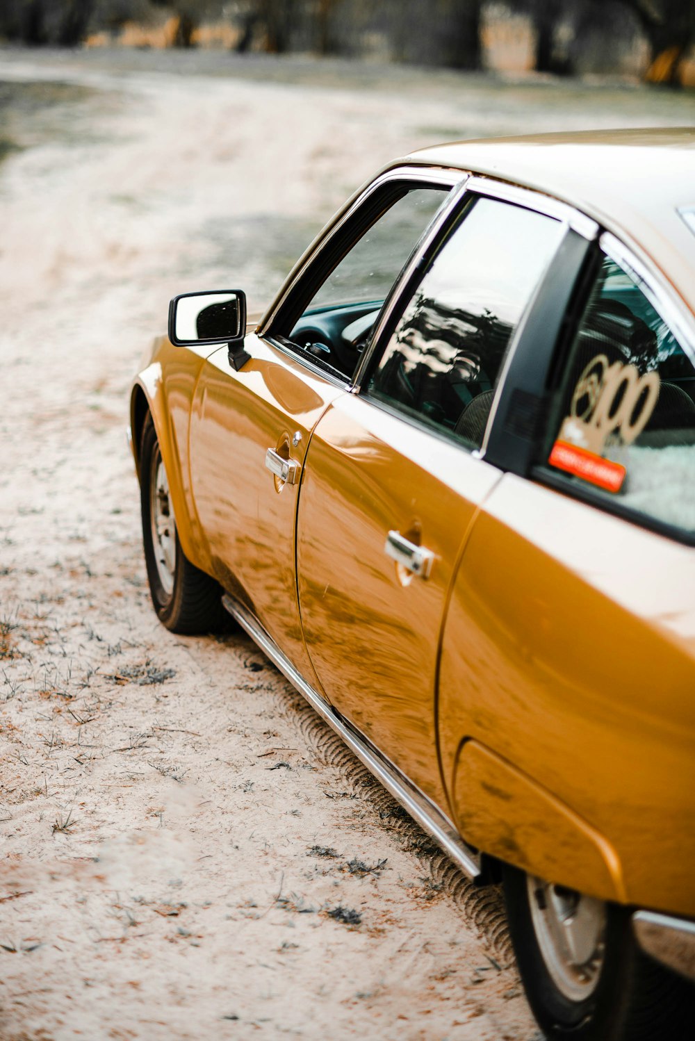 yellow car on gray road during daytime