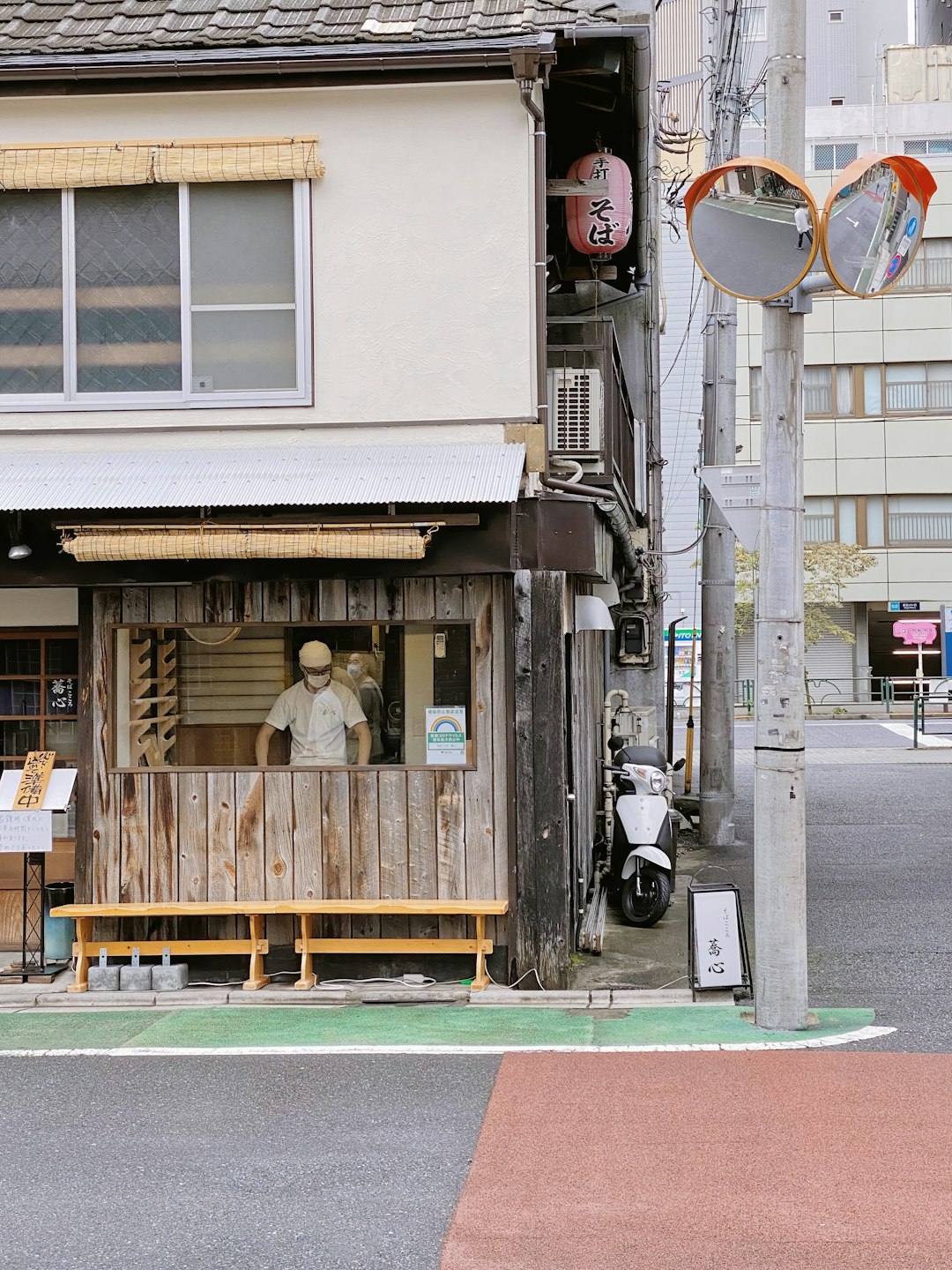 brown wooden store with red and white street sign