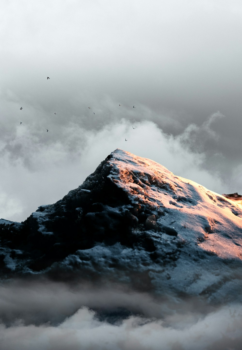 snow covered mountain under cloudy sky during daytime