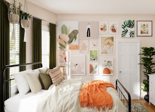 white bed with orange blanket