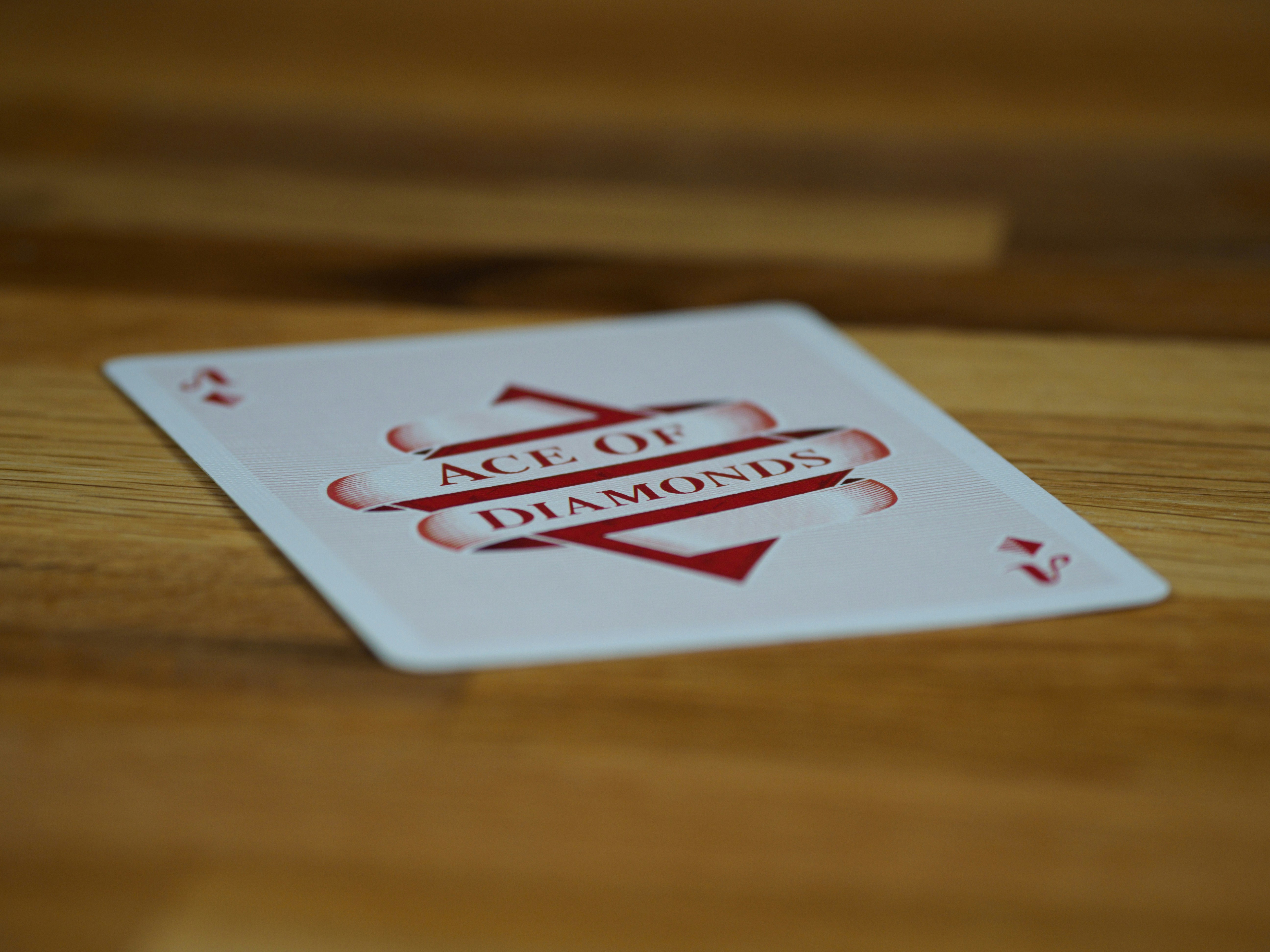 cards, playing cards, gambling, close up, bokeh, wood background, product shot, focus, deal, 
