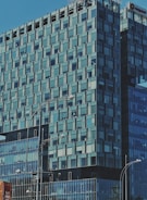 A bustling commercial office space with glass windows reflecting city life.