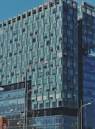 A modern office building with large windows and a busy street view.