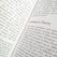 A close-up view of an open book displaying text. The title 'Schrödinger's Theory' is prominently featured, surrounded by content discussing matrix mechanics and quantum theory. The pages are filled with dense text in a formal typeface.