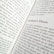 A close-up view of an open book displaying text. The title 'Schrödinger's Theory' is prominently featured, surrounded by content discussing matrix mechanics and quantum theory. The pages are filled with dense text in a formal typeface.
