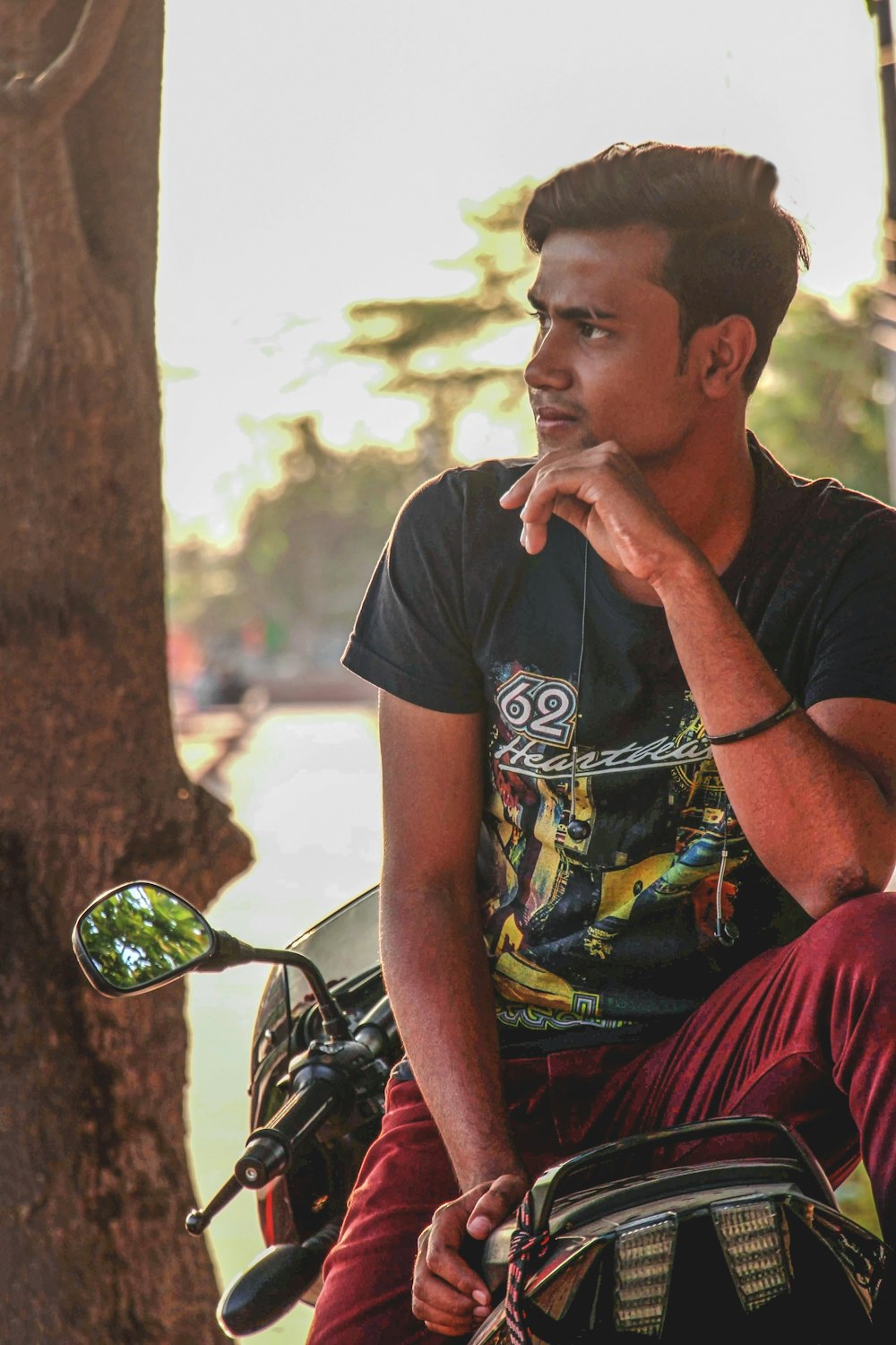 man in black crew neck t-shirt sitting on black motorcycle