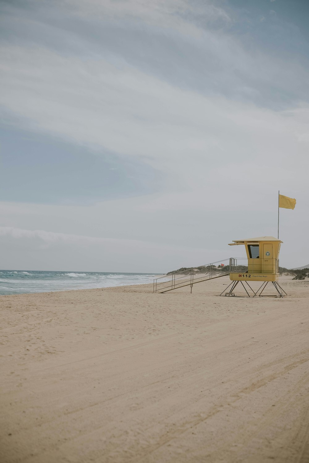 brown wooden chair on beach during daytime