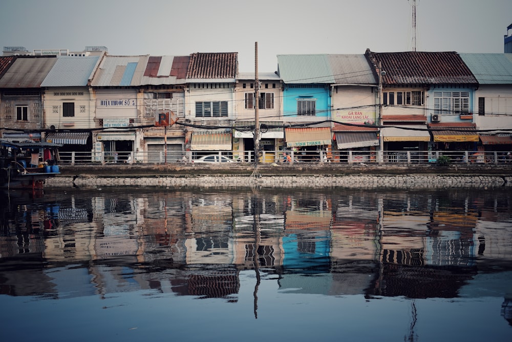 brown and white concrete building near body of water during daytime