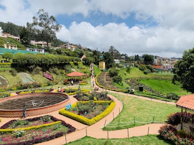 Residents enjoying a lush, landscaped garden with walking paths.