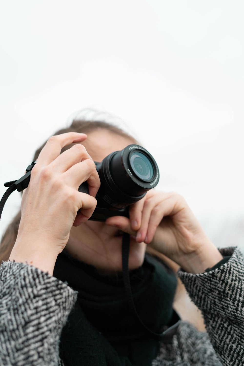 person holding black dslr camera