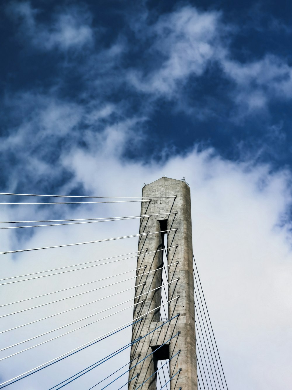 low angle photography of gray concrete building under blue sky during daytime