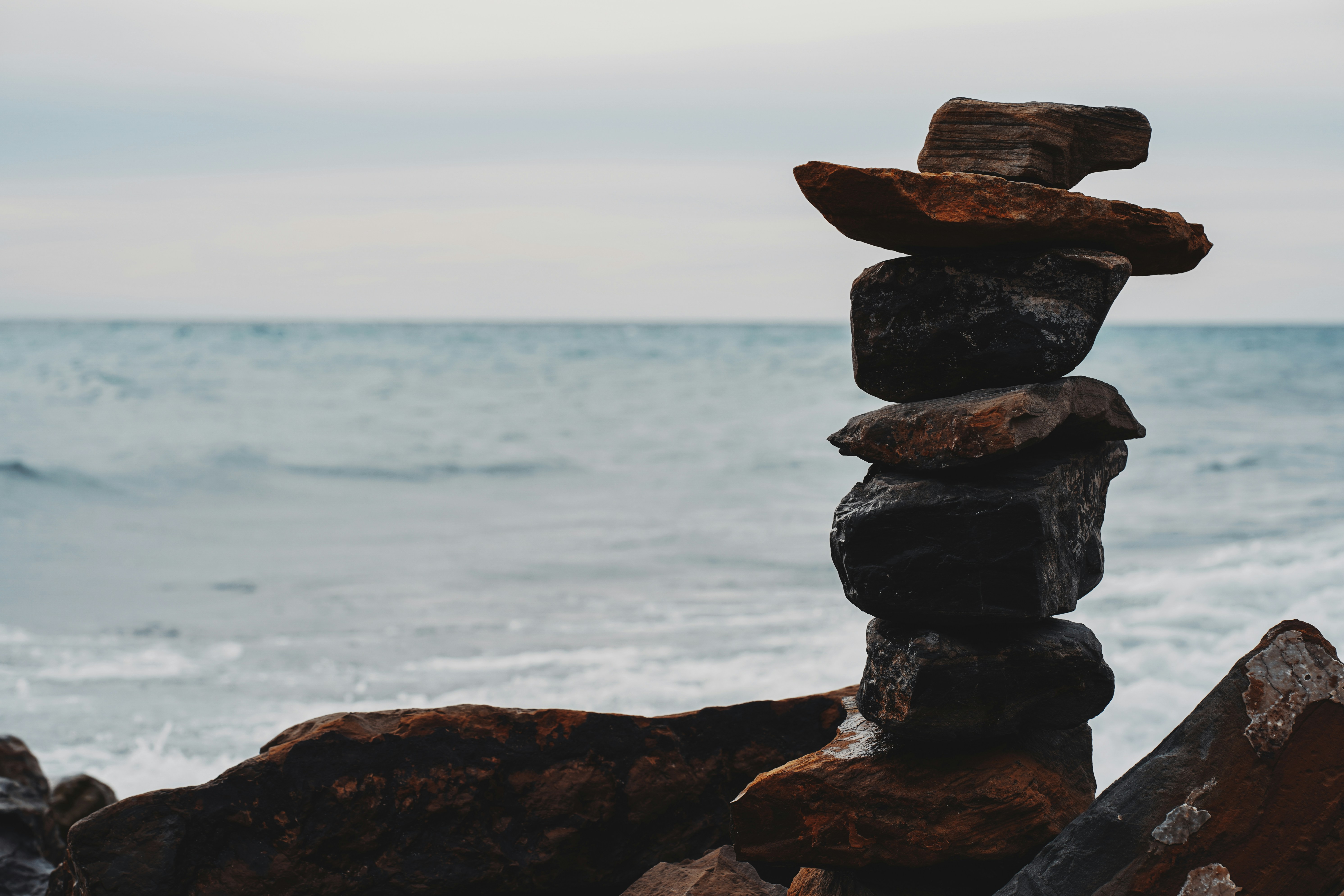 brown rock formation near body of water during daytime