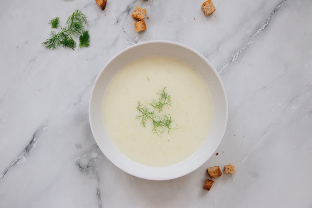 white ceramic bowl with green liquid