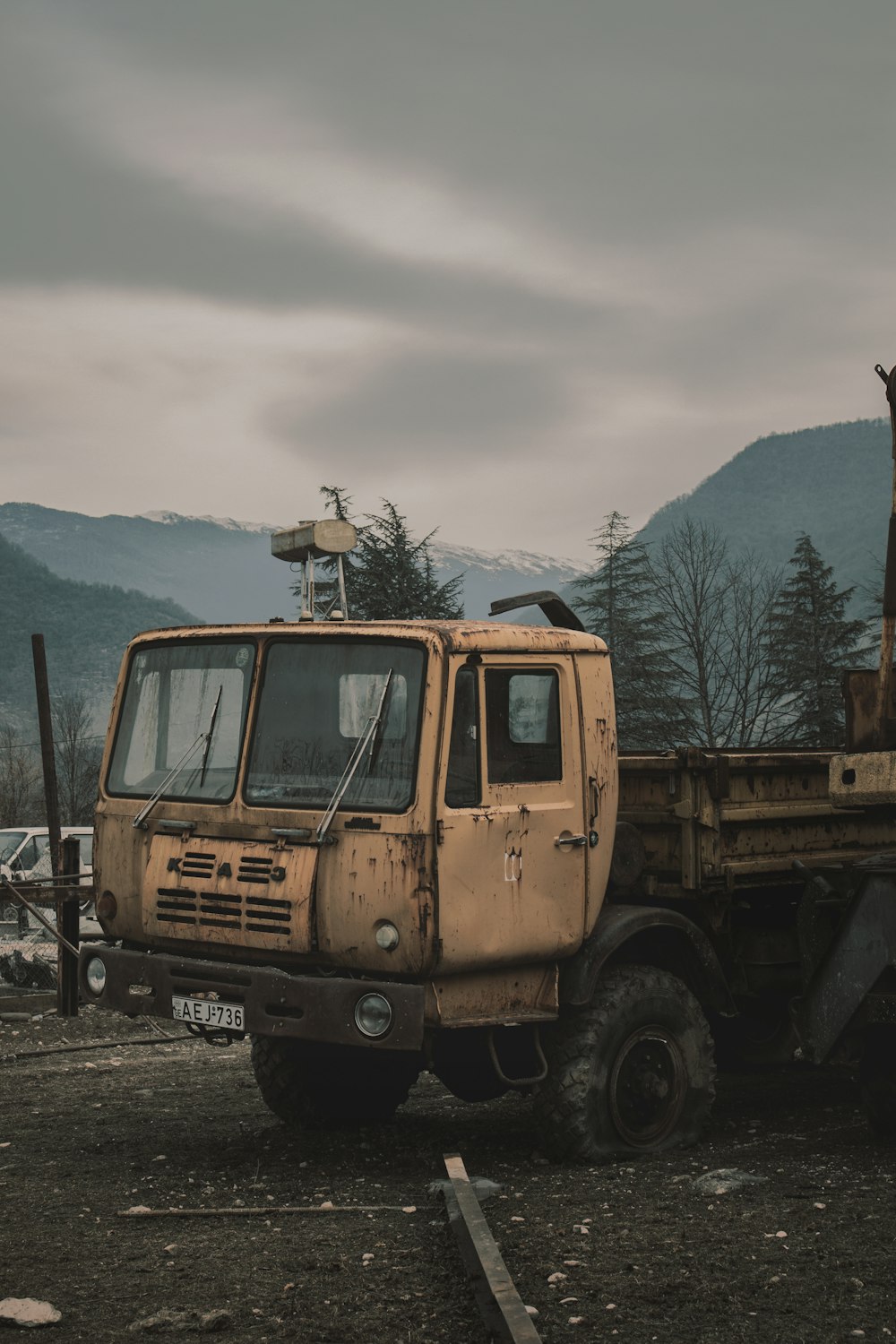 yellow truck on gray asphalt road during daytime